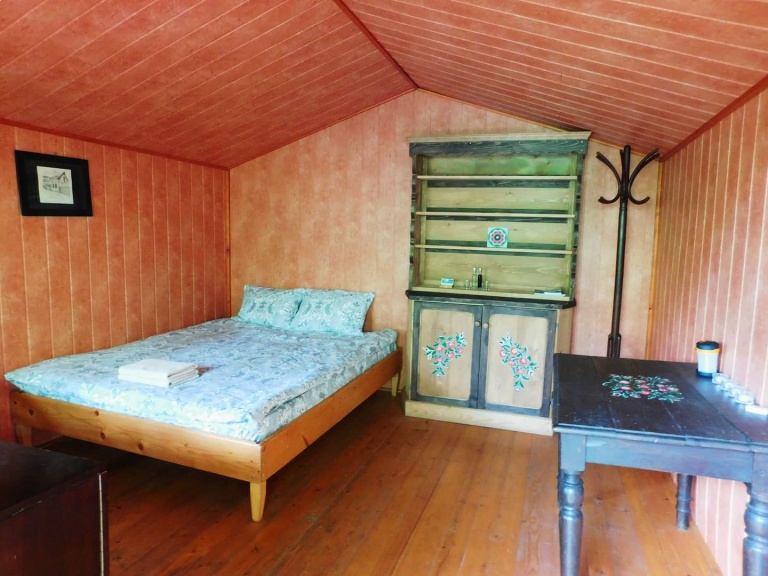 queensize bed in old cabin